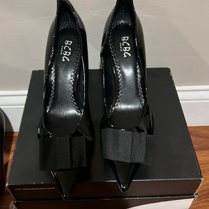 Black BCBGirls parent leather heel with black bow on front.